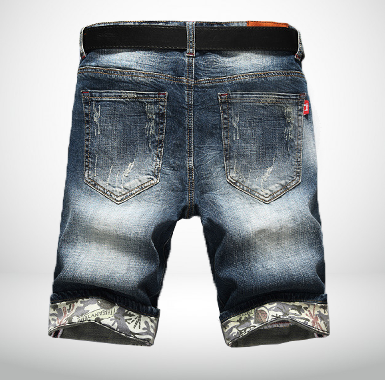 Denim floral trimmed shorts angled view showing distressing